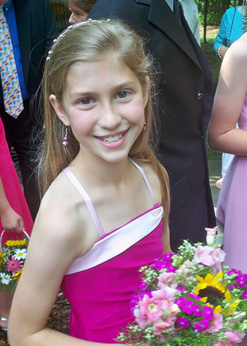 Maggie Elder, 10, holds a bouquet at the 2010 of her mother, Cyndi, to Jim McGinnis. The family never could have imagined that exactly one year later she would be battling cancer. 