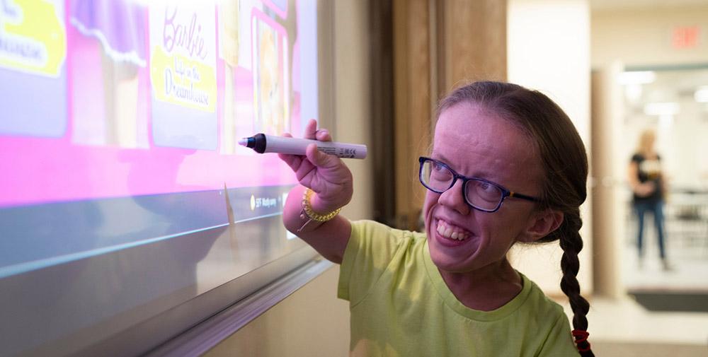Krystal Ciccarelli uses a smart white board at the Greensburg-based Westmoreland County Blind Association, which is one of the many human services agencies that would benefit from a Department of Human Services to help with case management and service coordination. Image by Jason Cohn.