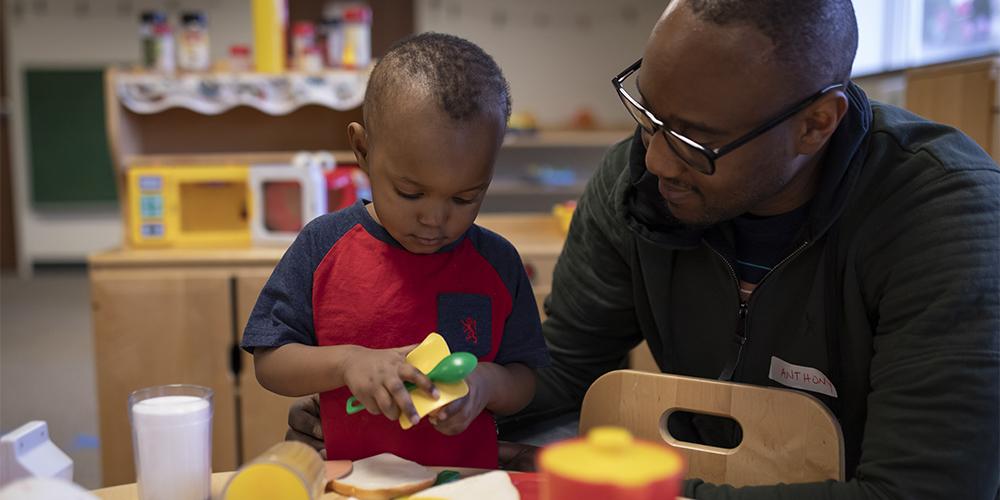 The ACHIEVA Preschool Readiness Program in Westmoreland County provides children and their parents space to gather for learning and socializing. They played games, ran an obstacle course, blew bubbles and snacked together. Mark Ngarava with his father, Anthony, are pictured. (Photo credit: Joshua Franzos.)