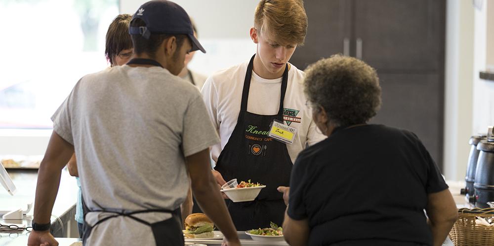 Zack Hegedus (center) and others spent a day volunteering at Knead Café in New Kensington through a CFWC summer philanthropy internship program. 