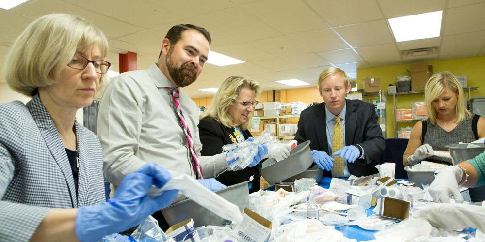 Phil Koch, CFWC's executive director (second from left), joins with fellow Chartered Advisors in Philanthropy (CAP) class members in packing medical supplies at Global Links, a nonprofit that focuses on disaster relief.